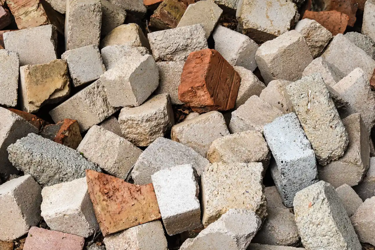 Pile of broken concrete and masonry rubble stacked for haul-off and recycling
