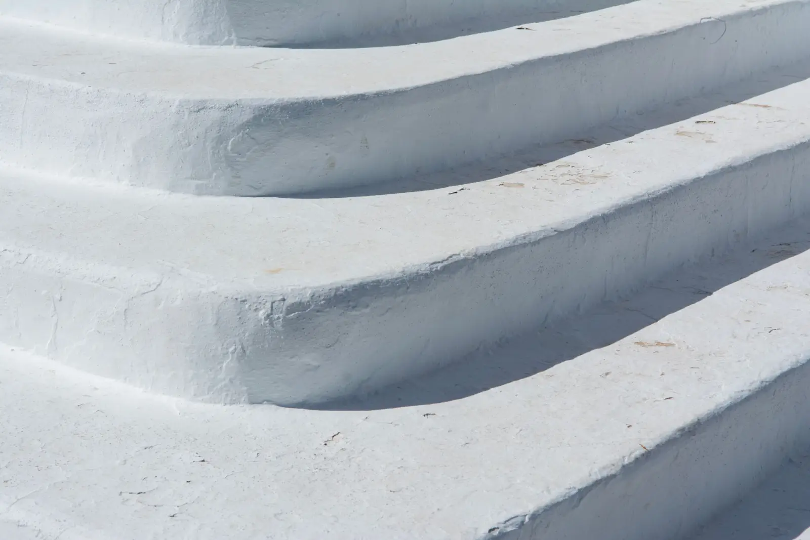 Close-up of clean light-grey concrete steps with even risers and tooled nosings
