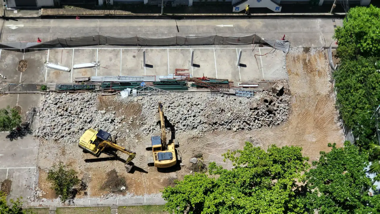 Aerial view of an excavated site with excavators working and aggregate stockpiled alongside