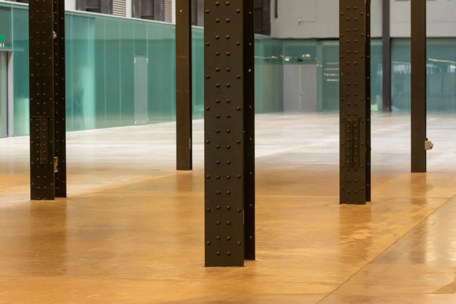 Modern industrial interior with steel columns and a smooth polished concrete floor